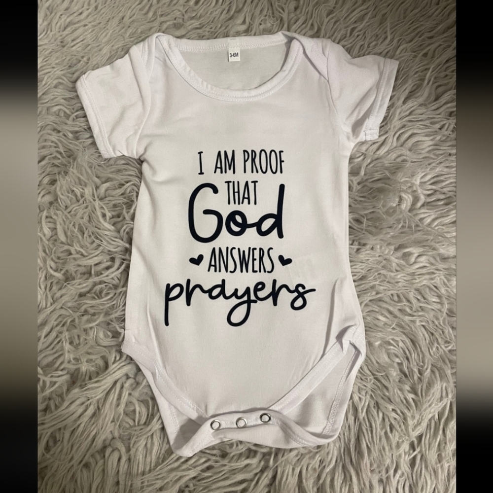 White Baby One-Piece Bodysuit with 'God Answers Prayers' Script